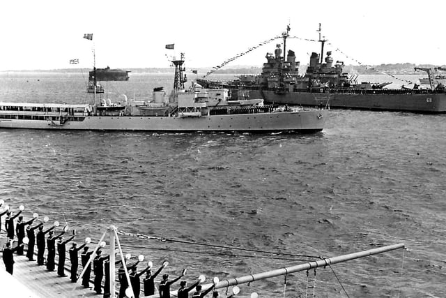 HMS Surprise passes between the USS Baltimore and HMS Vanguard during the 1953 Fleet Review.