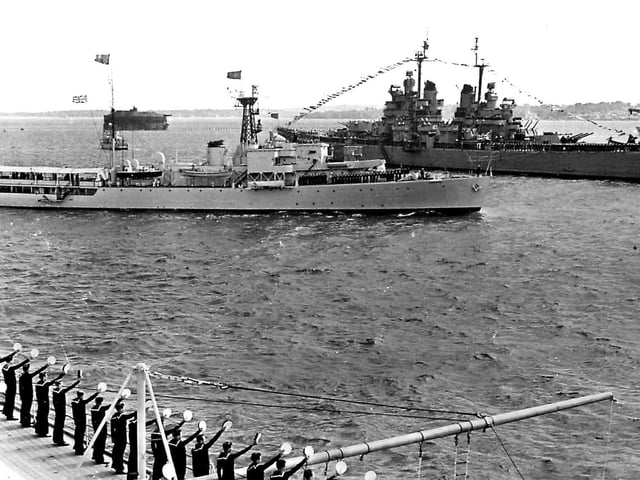 HMS Surprise passes between the USS Baltimore and HMS Vanguard during the 1953 Fleet Review.