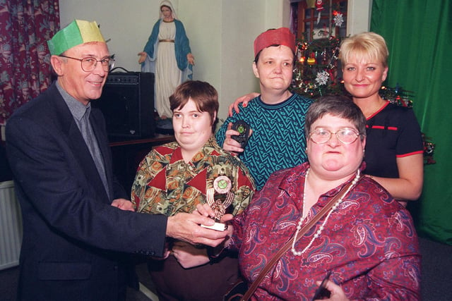 Pictured at St Wilfreds Day Centre, Queens Road, Sheffield, in 1997 where sports awards were presented at the Christmas dinner for homeless and needy people. Seen is the Bishop of Hallam John Rawsthorne as he presents the winning rounders team with their trophies. The team includes Shirley Flack, Janet Pedley, Sue Alderson, and Caroline Morton.