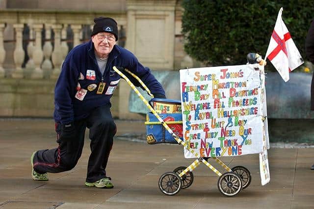 Marathon man John Burkhill with his pram, but not his green wig, on February 22, 2005
