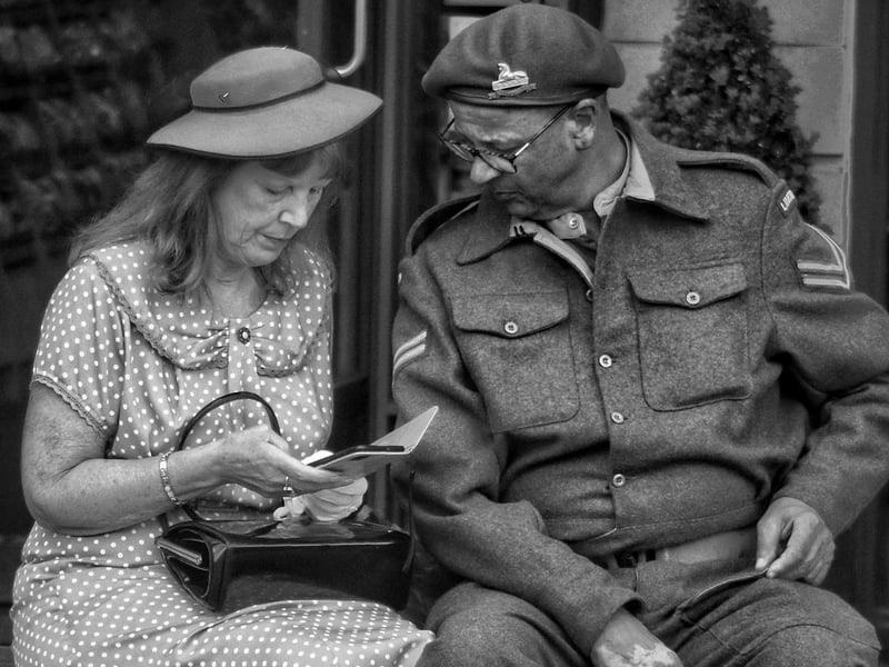 A couple in costume taking a seat for a rest.