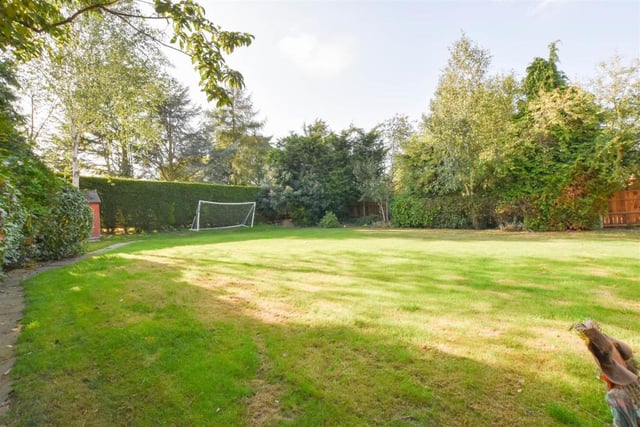 Hitting the back of the net is the back garden, which scores on appearance. A well-kept lawn is surrounded by mature trees, hedges and shrubs.