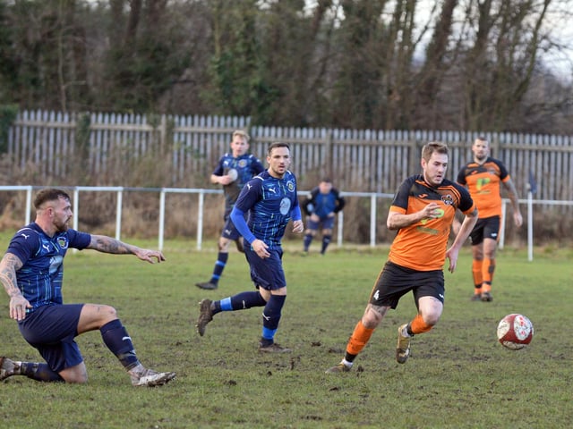 Scawthorpe's Alex Rennie gets away from his man.