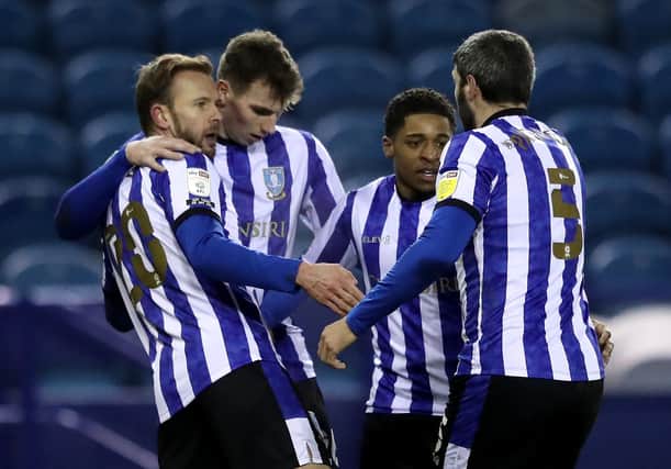 SHEFFIELD, ENGLAND - FEBRUARY 09: (L-R) Jordan Rhodes of Sheffield Wednesday celebrates with teammates Liam Shaw, Kadeem Harris and Callum Paterson after scoring their team's first goal during the Sky Bet Championship match between Sheffield Wednesday and Wycombe Wanderers at Hillsborough Stadium on February 09, 2021 in Sheffield, England. Sporting stadiums around the UK remain under strict restrictions due to the Coronavirus Pandemic as Government social distancing laws prohibit fans inside venues resulting in games being played behind closed doors. (Photo by Alex Pantling/Getty Images)