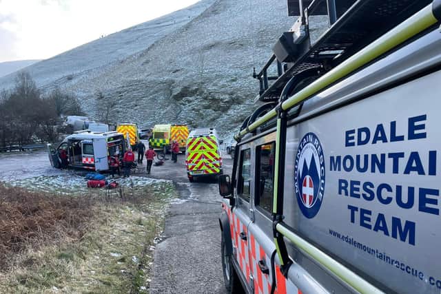 Mountain rescue teams and ambulances below Mam Tor near Castleton.