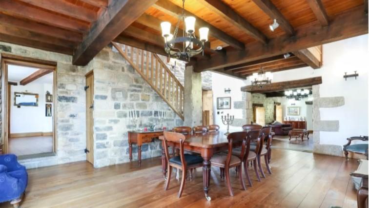 Exposed stonework and oak beams draw the eye in the dining room.