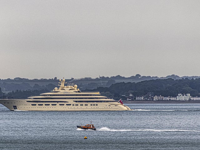Dilbar is 156m long - and it dwarfs the coastguard's boat in this picture