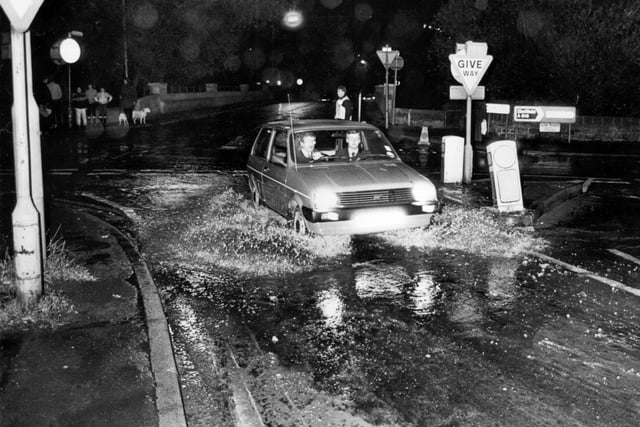 Driving through the flood caused after a water pipe burst at Oughtibridge in 1985