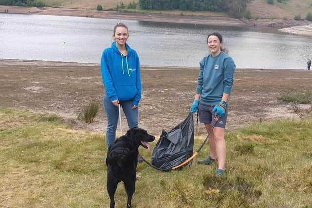 Derbyshire university students Rosie and Stacey and their dog join in the clean-up