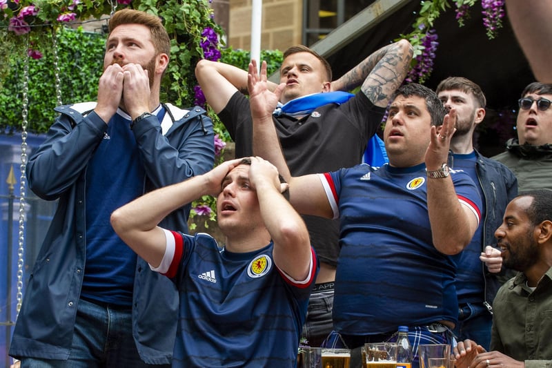 These fans almost couldn't bear to watch as Scotland missed another opportunity to score a goal in Monday's match.