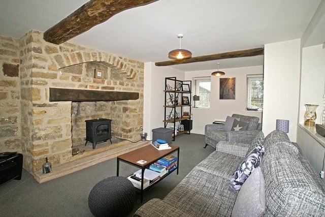 The exposed stone fireplace and timber beams highlight the age of the property.