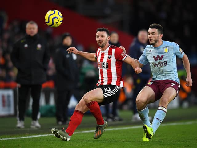 Enda Stevens of Sheffield United and John McGinn of Aston Villa during the Premier League match between Sheffield United and Aston Villa at Bramall Lane on December 14, 2019 in Sheffield, United Kingdom. (Photo by Clive Mason/Getty Images)