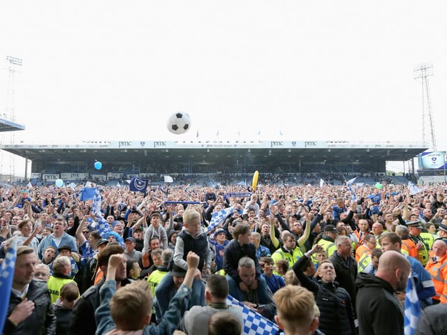 Fans invade the pitch to toast the triumph.