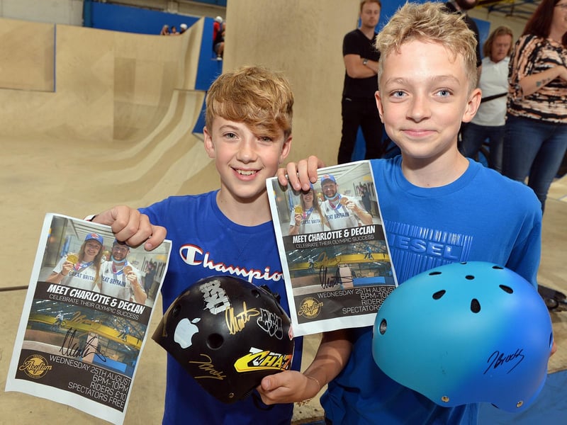 Charlie Noble and Charlie Merritt with a signed helmet and poster