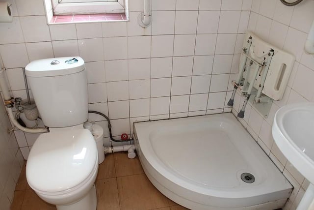 OK, it needs sprucing up, but the ground-floor bathroom boasts all you need. A shower tray is complemented by a pedestal wash hand basin and low-level WC.
