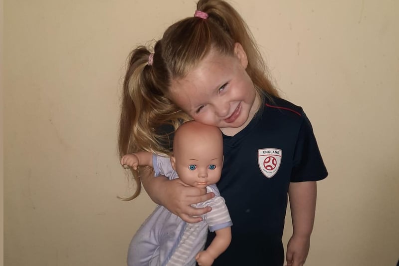 Three-year-old Lucy-Ann and her doll.