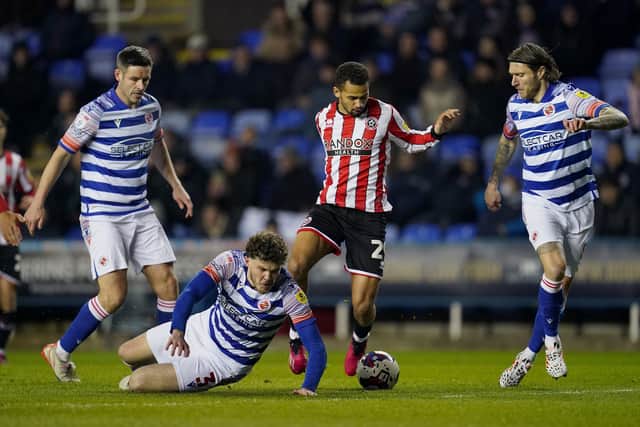 Sheffield United's Iliman Ndiaye (centre) gets away from Reading's Tom Holmes (on ground): Nick Potts/PA Wire.