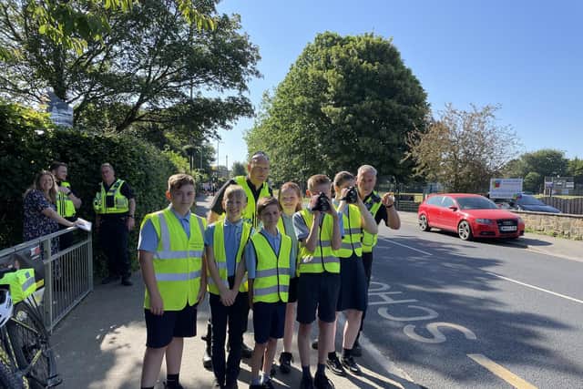 Children are raising awareness of road safety in front of Wickersley Northfield Primary School.
