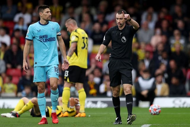 Jarred Gillett, the match referee interacts with Federico Fernandez of Newcastle United   during the Premier League match between Watford and Newcastle United at Vicarage Road on September 25, 2021 in Watford, England.