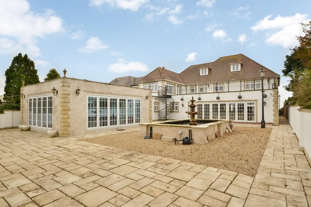 This huge five-bedroom Portsdown Hill home in Portsmouth is up for raffle. Pictured is one view of the property's garden, pond and detached orangery, left.