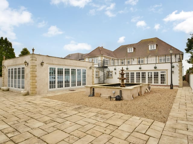 This huge five-bedroom Portsdown Hill home in Portsmouth is up for raffle. Pictured is one view of the property's garden, pond and detached orangery, left.
