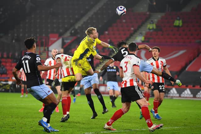 Aaron Ramsdale of Sheffield United clears the ball under pressure from Tyrone Mings of Aston Villa  during the Premier League match between Sheffield United and Aston Villa at Bramall Lane . (Photo by Clive Mason/Getty Images)