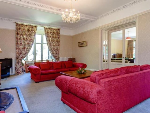 The living room offers plenty of natural light, high ceilings and adjoins the separate games room.