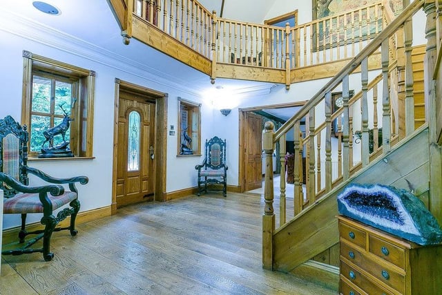 As you enter Loxley Lodge, you are greeted by this spectacular, double-height reception hall, with hardwood flooring. It has a split staircase, leading to a galleried landing.