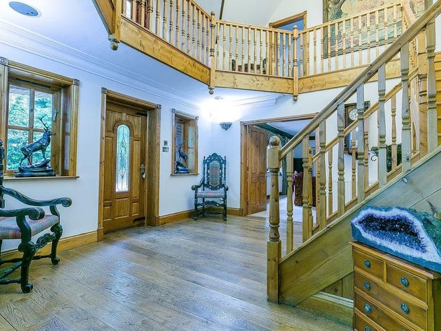 As you enter Loxley Lodge, you are greeted by this spectacular, double-height reception hall, with hardwood flooring. It has a split staircase, leading to a galleried landing.