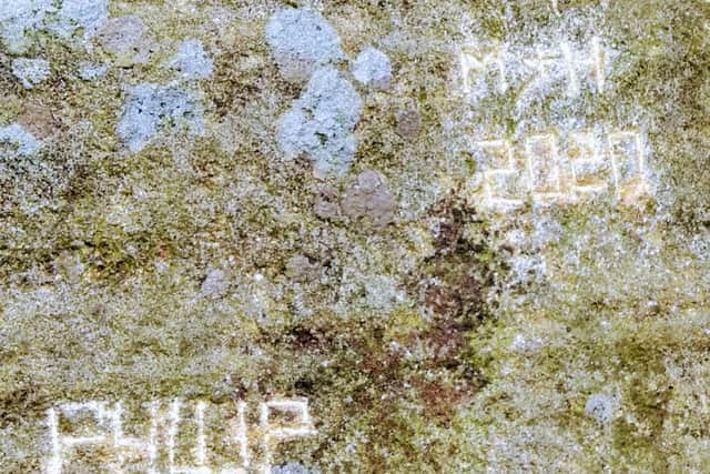 Words have been chipped into the side of The Head Stone rock monument in the Peak District National Park