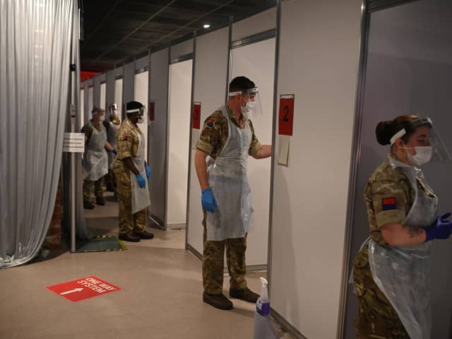 British Army soldiers, 19th Regiment Royal Artillery 5 Battery, staff testing booths inside Anfield Stadium in Liverpool (Photo by Oli SCARFF / AFP) (Photo by OLI SCARFF/AFP via Getty Images)