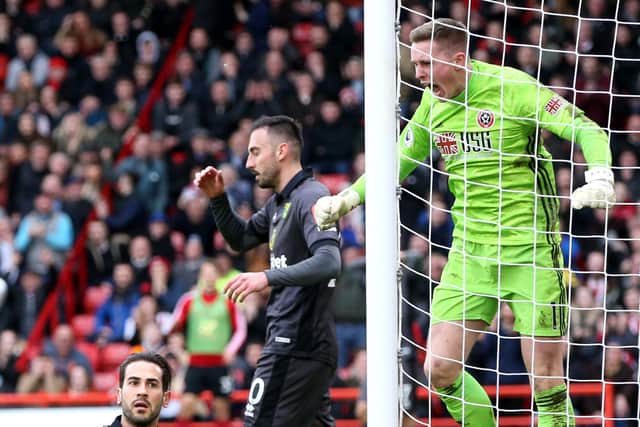 Dean Henderson of Sheffield United reacts after saving a shot from Mario Vrancic (Photo by Nigel Roddis/Getty Images)