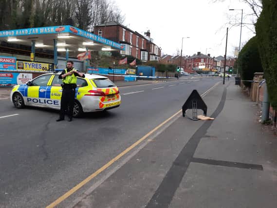 Police guard the crime scene on Burngreave Road, Sheffield