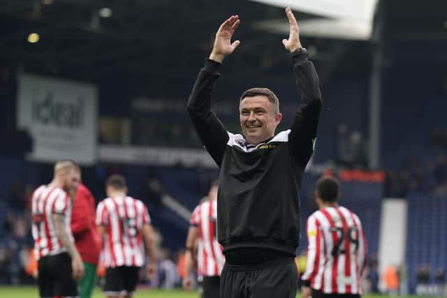 Paul Heckingbottom, manager of Sheffield United, celebrates the win at West Brom with his travelling fans: Andrew Yates / Sportimage