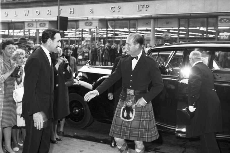 Wearing a kilt and sporran, Prince Philip the Duke of Edinburgh arrives at the North British hotel to meet officers of the Queen's Own Highlanders in July 1965.