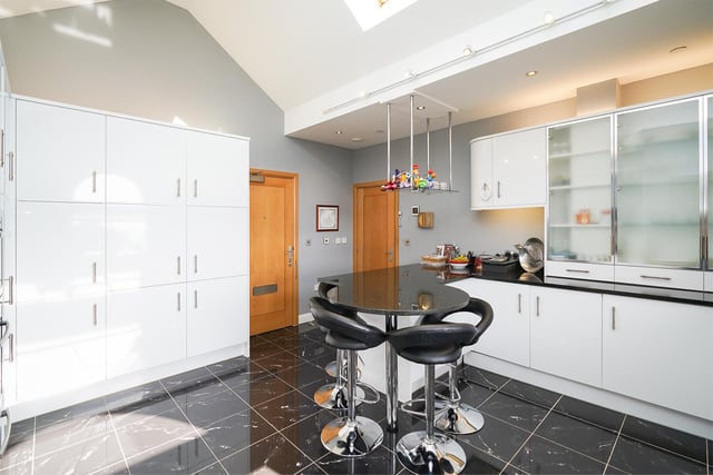 A superbly appointed breakfast kitchen includes a full range of integrated appliances.
