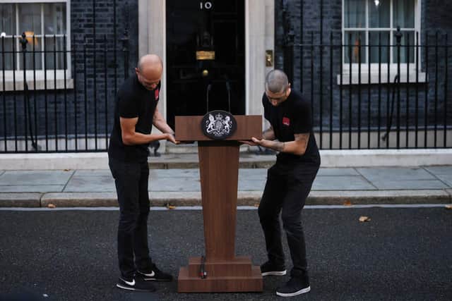 LONDON, ENGLAND - SEPTEMBER 06: Staff members bring out a lectern in preparation for farewell remarks by British Prime Minister Boris Johnson at Downing Street on September 6, 2022 in London, England. Boris Johnson is stepping down following the election of Liz Truss, the former foreign secretary, as Conservative Party leader. (Photo by Dan Kitwood/Getty Images)