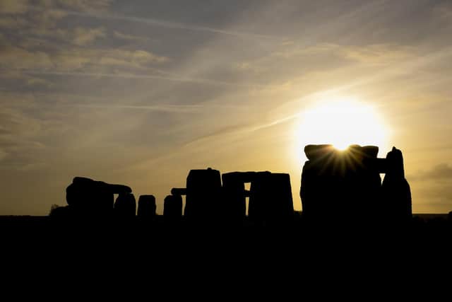 AMESBURY, ENGLAND - DECEMBER 22:  The sun rises over Stonehenge,  as people take part in solstice ceremony at the ancient neolithic monument of Stonehenge near Amesbury  (Photo by Matt Cardy/Getty Images)