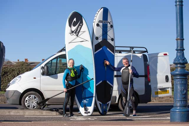 Sandy Atkins and Martin Foster out for their daily excercise, paddle boarding in Southsea. Picture: Habibur Rahmann