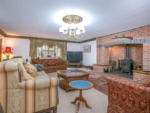 The mighty sitting-room, with its exposed brickwork, wooden beams, Inglenook fireplace and wood burner. It even has a fitted music-system.