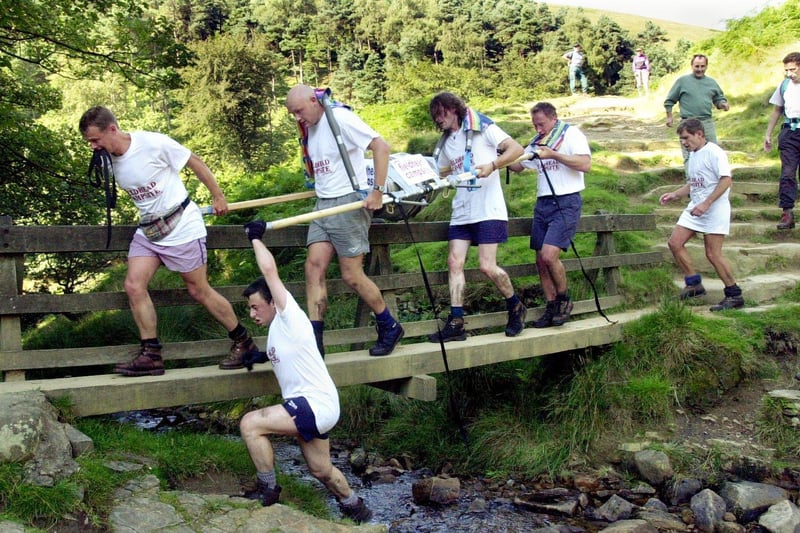 Members of the Edale Field Head rangers team on their way to the finish of the Great Kinder Beer Barrel challenge race between the Snake Inn on the Snake Pass over Kinder Scout to finish at the Old Nag's Head in Edale