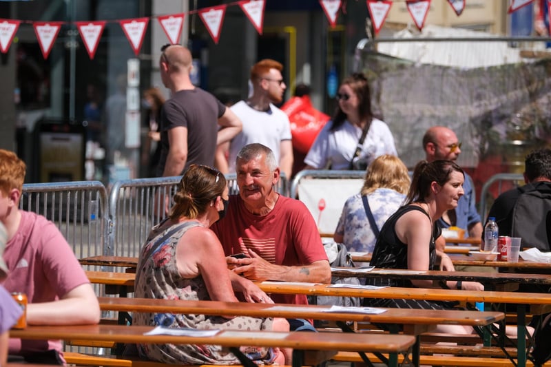 Shoppers enjoy the European market in the scorching heat