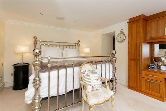 There are five generously sized bedrooms throughout the property, including one with a dressing room and en suite bathroom finished in marble tiling.