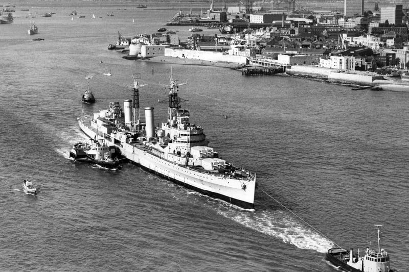 The Royal Navy Town-class light cruiser HMS Belfast is waved away under tow from tugboats on her last voyage from Portsmouth Dockyard to her new berth in London as a floating museum on 2 September 1971 in Portsmouth, United Kingdom.  (Photo by Central Press/Hulton Archive/Getty Images).