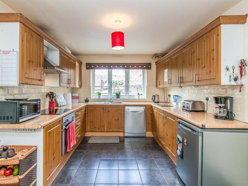 The main kitchen area is of a good size and boasts all the amenities you need, including a range of wood-effect wall and base units, integrated electric oven, stainless-steel sink and ceramic tiled floor. There is also space and plumbing for a dishwasher and an under-counter fridge.