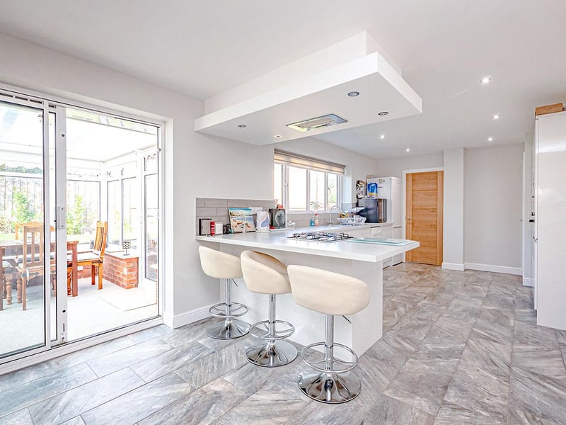 To the rear of the kitchen is a breakfast bar area and space large enough to accommodate a family dining table.