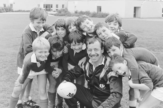 Former Jed-Forest and Scotland scrum-half Roy Laidlaw with some young hopefuls from Wilton Primary School at Stirches, Hawick, October 1988.