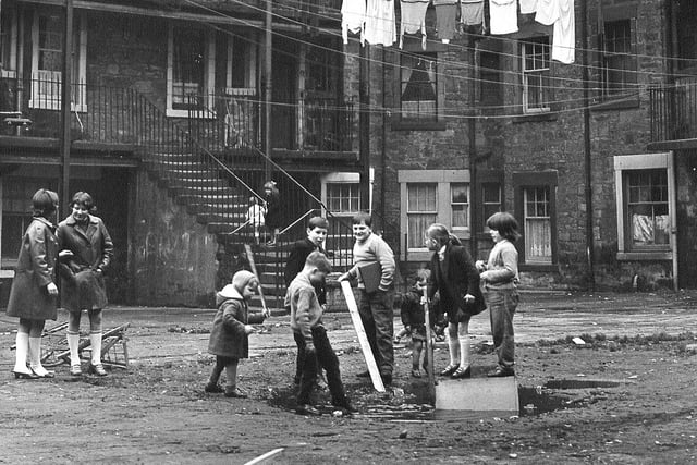 Children playing behind flats at Ballantyne Road, Leith, 1970.