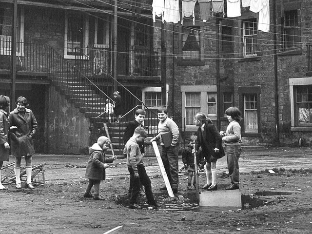 Children playing behind flats at Ballantyne Road, Leith, 1970.