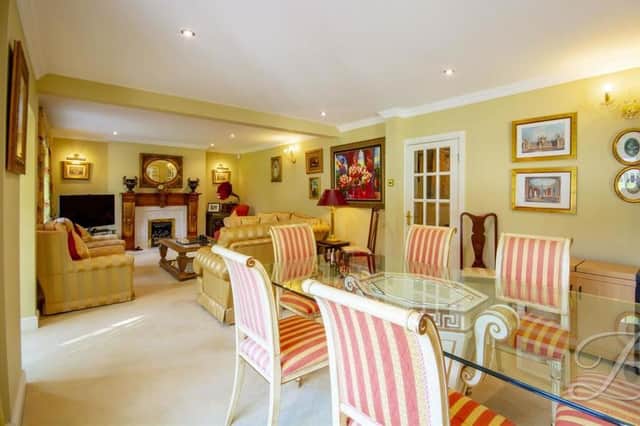 The luxurious dining room has so much going for it. Features include a carpeted floor, fireplace with surround, two bay front windows and central-heating radiators.